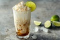 Dirty Soda with Cream Topping and Lime in Tall Glass Royalty Free Stock Photo