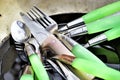 Dirty spoons, forks and knives are in the old pan in the sink af Royalty Free Stock Photo