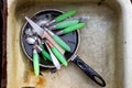 Dirty spoons, forks and knives are in the old pan in the sink af Royalty Free Stock Photo