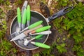 Dirty spoons, forks and knives are in the pan on a stump wood af Royalty Free Stock Photo