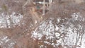 Dirty spring waterfall with tourists. Stock. Top view of dirty waterfall flowing down forest mountain with melting snow Royalty Free Stock Photo