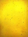 Dirty stained yellow concrete wall as grunge texture and background image