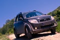 Dirty SUV on a mountain road Royalty Free Stock Photo