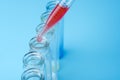 Dirty test tubes on blue background medical research.