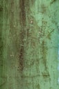 Dirty texture of plaster and green paint, shabby aged surface, remnants of peeling cracked stucco, grunge uneven wall Royalty Free Stock Photo