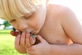 Dirty Toddler Playing Outside Kissing Frog Royalty Free Stock Photo