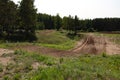 Dirty track for sports activities of motorcyclists and buggy, forest road with hills