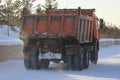 Dirty truck carrying the snow on the street in winter