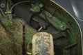 Dirty underside of robotic lawnmower, motorized lawnmower being serviced on a table after a year of use in the mud and grass.