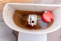 Dirty unhygienic rusty and calcified flush tank of toilet with limescale and rust stains and scum need to be cleaned and repared