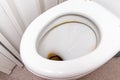 Dirty unhygienic toilet bowl with limescale stain at public restroom close up Royalty Free Stock Photo