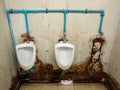 The dirty urinal row of the temporary toilet in the railway station