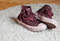 Dirty used shoes on carpet Royalty Free Stock Photo