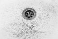 Dirty wash hand basin showing grungy drain with bits of hair Royalty Free Stock Photo