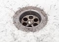 Dirty wash hand basin showing grungy drain with bits of hair Royalty Free Stock Photo