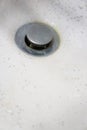 Dirty wash hand basin showing grungy drain with bits of hair Royalty Free Stock Photo