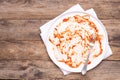 Dirty white plate with leftovers on wooden table, top view