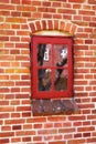 Dirty window in an old red brick house outside. Background of an architectural built structure on an exterior wall with