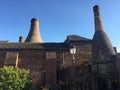 Dirty window onto bottle kilns.