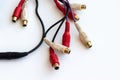 Dirty wires with black, red and white audio video connectors RCA jack on a white scratched work table Royalty Free Stock Photo