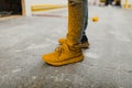 Dirty work boots with yellow paint Royalty Free Stock Photo