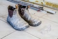 Dirty worker boots and construction tools