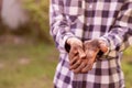 dirty working farmer hands in soil standing in gardens