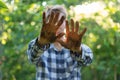 dirty working farmer hands in soil standing in gardens