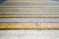 Dirty yellow-white pedestrian crossing on a wide road. Royalty Free Stock Photo
