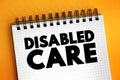Disability care - practical help with anything from everyday tasks like housework, bathing and continence, text on notepad Royalty Free Stock Photo