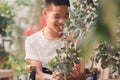 Disability child on wheelchair looking plant Royalty Free Stock Photo