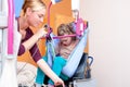 Disabled child being lifted into a wheelchair Royalty Free Stock Photo