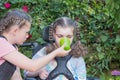 A disabled child in a wheelchair being cared for by a voluntary care worker.