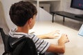 disability and education. faceless child in a wheelchair at a desk, in front of a computer screen Royalty Free Stock Photo