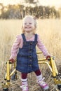 Disability photo of a cute little disabled girl walking with a special walker