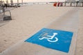 Disability sign and path road for wheel chair on the sea beach. beach places for people with disabilities Royalty Free Stock Photo