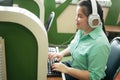 Disability young blind person happy woman in headphone typing on computer keyboard working in creative workplace office