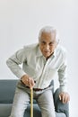 Disable and injury senior asian man try to stand up with walking cane, Knee pain and joint disease in old man.