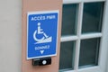 Disabled accessible arrow entry sign post with wheelchair handicap logo pmr means  people someone with reduced mobility on wall Royalty Free Stock Photo