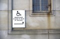 Disabled accessible push button buzzer for assistance sign at building entrance Royalty Free Stock Photo