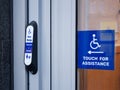Disabled accessible push button buzzer for assistance sign at building entrance Royalty Free Stock Photo