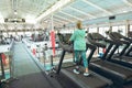 Disabled active senior woman exercising on treadmill in fitness studio Royalty Free Stock Photo