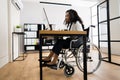 Disabled African Worker In Wheelchair Working