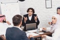 Disabled arab man in wheelchair working in office. Man is doing presentation in fornt of coworkers. Royalty Free Stock Photo