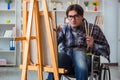 The disabled artist painting picture in studio Royalty Free Stock Photo