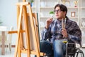 The disabled artist painting picture in studio Royalty Free Stock Photo