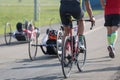 Disabled Athletes training with their Hand bike with Cyclist and Runners Close to Them