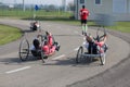 Disabled Athletes training with their Hand bike with Runner Close to Them