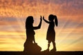 Disabled baby girl with prosthetic legs with her mom outdoors at sunset. Royalty Free Stock Photo