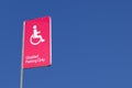 Disabled Badge Holders Only at Car Park Sign Post in Blank Blue Sky Royalty Free Stock Photo